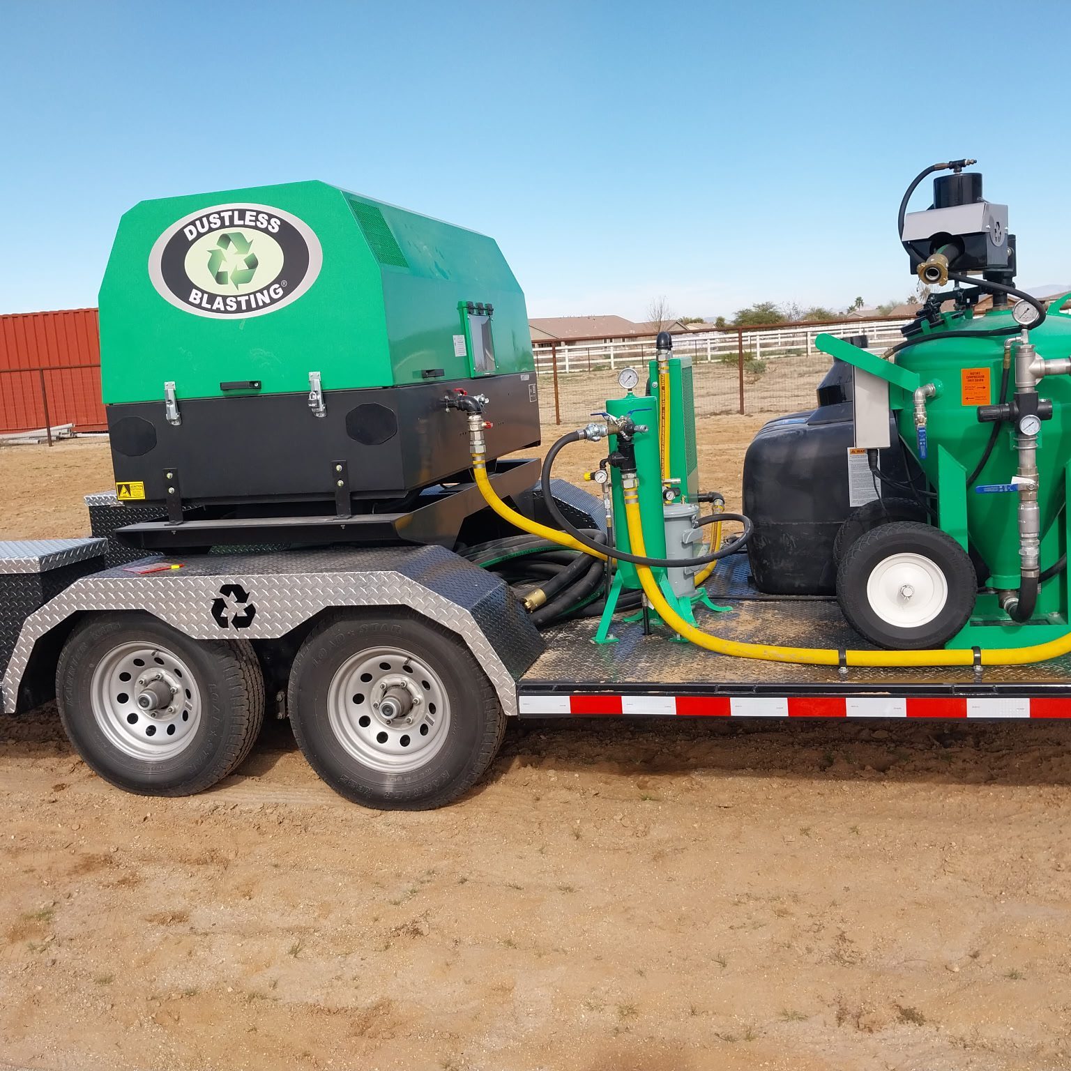 Mobile industrial machine mounted on a trailer in an outdoor setting.